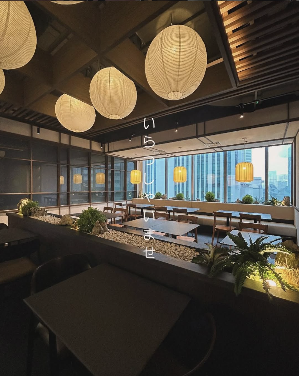 JINSEI main dining floor with paper lanterns and Jakarta city views